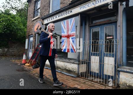 Coalbrookdale, Telford, Shropshire. 5 juin 2022 la fête est terminée ! Les drapeaux sont toujours là, mais la fête du Jubilé de platine de la Reine est terminée et c'est une courte promenade à pied pour le musicien Neil Gray après avoir divertissant les villageois près de sa maison. Crédit : Dave Bagnall. Coalbrookdale, Telford, Shropshire. 5 juin 2022 Banque D'Images