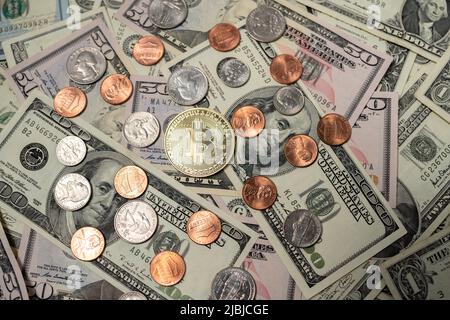Bitcoin sur les billets en dollars. Une facture de cent dollars à côté de pièces en bitcoin d'or et de pièces en dollars. Des centimes aux quartiers des États-Unis. Concept d'échange de crypto Banque D'Images