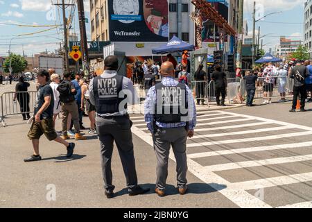 Des officiers du NYPD en armure à Bushwick, Brooklyn, à New York, pendant le Parti collectif de Bushwick annuel samedi, 4 juin 2022. La musique et la fête ont apporté certains mais la véritable attraction a été les nouvelles peintures murales par les artistes du graffiti qui décorent les murs des bâtiments que le collectif utilise. (© Richard B. Levine) Banque D'Images