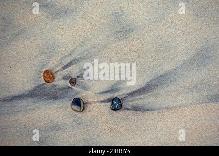 Quatre pierres sur la plage de sable humide de la côte danoise de la mer du Nord Banque D'Images