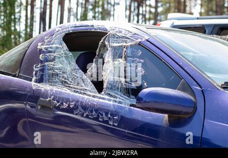 Incident criminel. Se fracassant dans une voiture garée dans la rue. Vitre latérale cassée et habitacle derrière. Un crime commis par un voleur, Banque D'Images