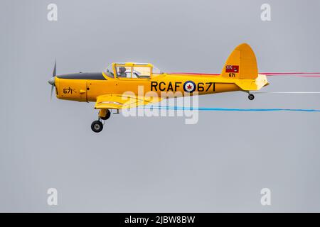 1952 DHC Chipmunk T.22 (G-BNZC) en vol au Shuttleworth Jubilee Airshow avec une banderole rouge blanche et bleue célébrant le Queens Platinum Jubilee Banque D'Images