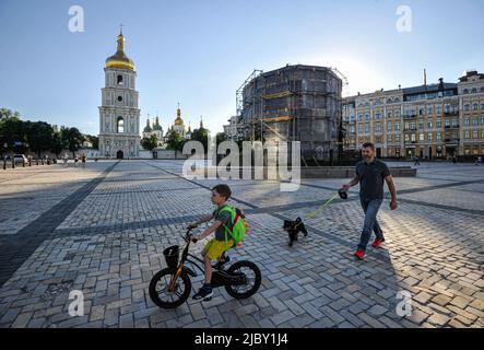 Borodyanka, Ukraine. 08th juin 2022. Un homme avec son enfant et un chien passe devant un monument à Bohdan Khmelnytsky, qui a été protégé par une structure protectrice contre les attaques à la roquette de l'armée russe devant la cathédrale Sainte-Sophie pendant l'invasion russe de l'Ukraine. La Russie a envahi l'Ukraine le 24 février 2022, déclenchant la plus grande attaque militaire en Europe depuis la Seconde Guerre mondiale Crédit : SOPA Images Limited/Alamy Live News Banque D'Images