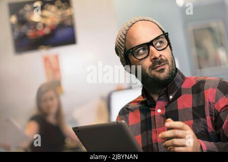 Businessman using digital tablet in office Banque D'Images