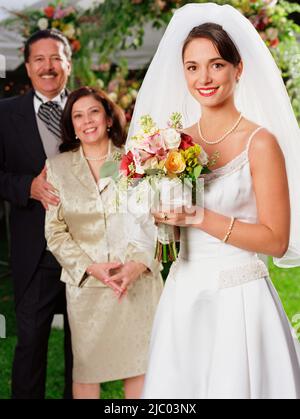 Bride pour l'appareil photo avec ses parents Banque D'Images