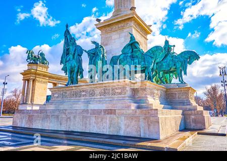 Les sculptures en bronze des sept chefs sur la base en pierre de la colonne du Monument du Millénaire sur la place des héros, Budapest, Hongrie Banque D'Images