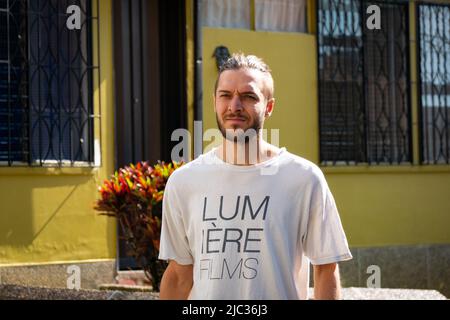 White Man marchant au milieu de la rue lors d'une Sunny Day Banque D'Images