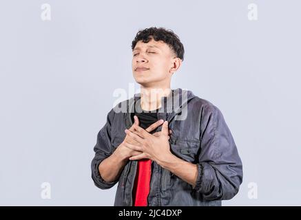 Attrayant positif regardant sympathique jeune homme avec le sourire sincère et charmant sentiment reconnaissant, Un homme attrayant paisible aimable reconnaissant Guy, amical Banque D'Images