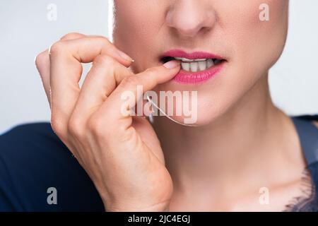 Close-up of a woman Biting son ongle Banque D'Images