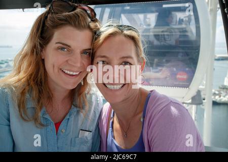 Deux dames souriantes sur la roue du Cap, grande roue, Waterfront, Cape Town. Banque D'Images