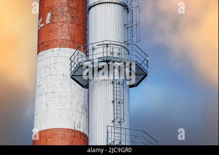 plusieurs cheminées industrielles contre un ciel fumé. fragment de cheminées hautes d'une centrale au charbon. Banque D'Images