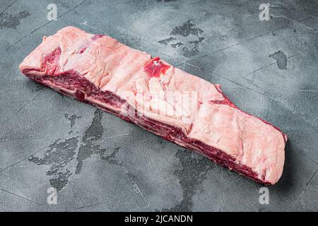 Côtes de viande crue, sur fond de pierre grise, avec espace de copie pour le texte Banque D'Images