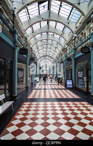 Great Western Arcade, qui abrite de nombreux détaillants indépendants dans le quartier commerçant du centre de Birmingham, avec son toit voûté et son plancher en damier. Banque D'Images