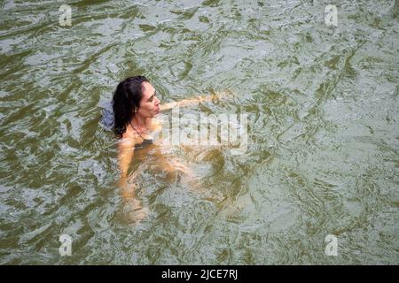 Cisneros, Antioquia, Colombie - 20 février 2022: Une femme blanche de Grèce est le bain dans le fleuve Banque D'Images