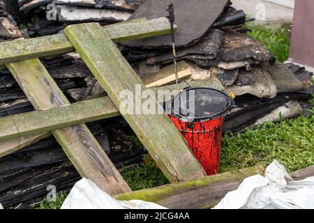 débris laissés après la réparation du pavillon. seau rouge avec mastic Banque D'Images