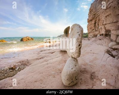 Pyramide d'équilibre en pierre rose sur la plage turquoise de Sassi Neri surplombant la mer Adriatique.beau paysage surplombant la mer, plage parfaite, Banque D'Images