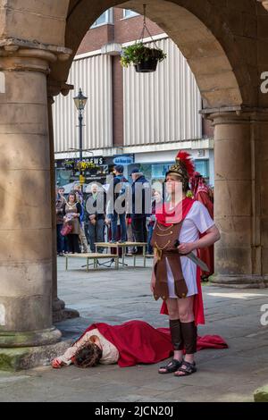 Un soldat romain garde le corps du Christ pendant le jeu de la passion qui se joue au Market Hall, Shrewsbury. Banque D'Images