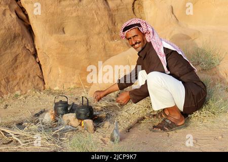 Bédouin homme avec bouilloire sur feu ouvert pour faire du thé, Wadi Rum, Jordanie Banque D'Images