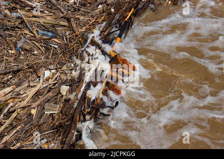 Pile de débris de bois et de déchets de plastique pendant une inondation, pollution de l'eau de l'environnement Banque D'Images