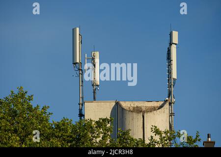 Trois mâts d'antenne pour les communications radio mobiles sur un toit Banque D'Images