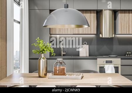 Vue sur l'avant de l'élégant intérieur ECO cuisine pièce avec ensemble de cuisine gris brillant, lampe moderne au-dessus de la table en bois, hotte de cuisine ronde et branche d'arbre vert Banque D'Images