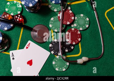 jetons de poker, argent, stéthoscope sur table de blackjack. Banque D'Images