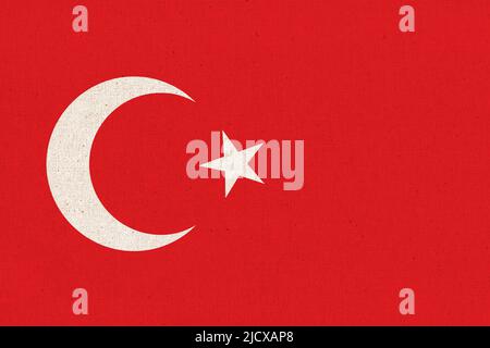 Drapeau de la Turquie. Drapeau turc sur la surface du tissu. Texture du tissu. Symbole national de la Turquie sur fond de motifs. République de Turquie Banque D'Images