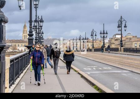 Photo d'une ancienne femme, française, qui s'efforce dans les rues de bordeaux, fait du rackalking actif sur le pont de Pierre. Banque D'Images