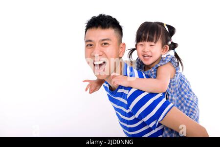 Père portant une petite fille Piggyback et ayant l'amusement Banque D'Images