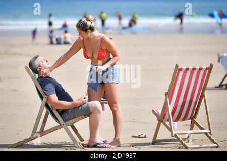 Photo du dossier datée du 16/07/19 des baigneurs de soleil qui appliquent de la crème solaire pendant le soleil chaud sur la plage de Towan à Newquay, en Cornouailles. Selon le groupe de consommateurs, lequel des écrans solaires coûteux à base de minéraux n'a pas fourni le niveau de protection revendiqué sur leur emballage ? Date de publication : vendredi 17 juin 2022. Banque D'Images