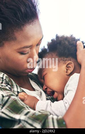 Je n'aime pas quand c'est triste. Photo courte d'une jeune mère qui berce son bébé garçon. Banque D'Images