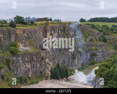 ***Vidéo disponible*** Mission: Impossible 7 scène d'accident de train de locomotive à Stoney Middleton, Derbyshire. La réplique du train à vapeur du British Railway Britannia est chassés de la falaise pour la scène finale de l'accident dans le dernier film à succès de Tom Cruise. La locomotive vole dans les airs dans un style spectaculaire avant de s'écraser dans la carrière ci-dessous. La scène a été filmée par deux hélicoptères et de nombreuses caméras à distance. Tom Cruise est arrivé juste avant la scène de l'accident final dans son hélicoptère personnel, il a voyagé autour du film avant d'atterrir dans les champs près de la voie ferrée au-dessus de la carrière. Le TR de vapeur Banque D'Images