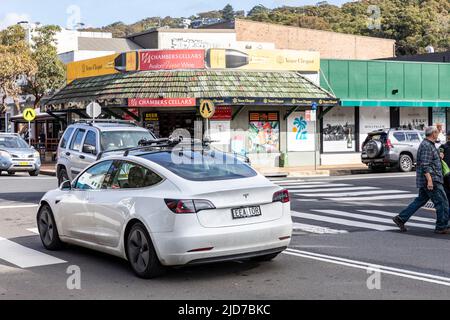 Tesla modèle 3, voiture électrique, année de construction 2019, conduite à travers la banlieue d'Avalon Beach après un passage à niveau pélican, Sydney, Nouvelle-Galles du Sud, Australie Banque D'Images