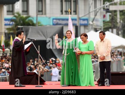 (220619) -- VILLE DE DAVAO, 19 juin 2022 (Xinhua) -- Sara Duterte-Carpio (2nd L) fait serment en tant que vice-présidente des Philippines en 15th comme son père, le président Rodrigo Duterte (1st R) et sa mère, Elizabeth, debout à côté d'elle à Davao, dans le sud des Philippines, au 19 juin 2022. Avocat et ancien maire de la ville de Davao, Duterte-Carpio prendra officiellement ses fonctions à 30 juin. Son mandat de six ans se termine sur 30 juin 2028. Duterte-Carpio gagné par la saisie 32. Banque D'Images