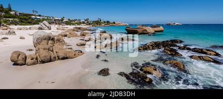 Rivage rocheux avec de grands rochers et maisons en bord de mer le long de l'océan Atlantique à Clifton Beach ; Cape Town, Western Cape, Afrique du Sud Banque D'Images