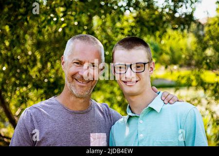 Portrait extérieur d'un père avec son jeune fils adulte; Edmonton, Alberta, Canada Banque D'Images