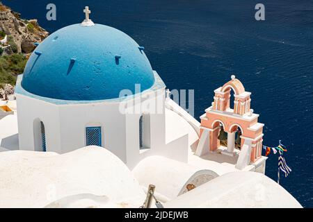 Dôme d'église bleu et clocher rose à Oia Banque D'Images