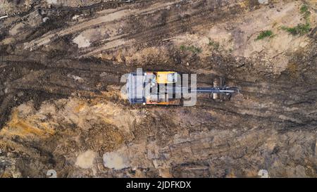 Tir extérieur de drone d'une machinerie lourde professionnelle dans le sable pendant les travaux sur un chantier routier d'une nouvelle autoroute. Photo de haute qualité Banque D'Images