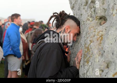 Stonehenge Wiltshire, Royaume-Uni. 21st juin 2022. Pour la première fois depuis 2019, les fêtards, dont Hippies et Druides, reviennent à Stonehenge pour célébrer le solstice d'été. Des milliers de personnes sont descendues sur les vieilles pierres pour assister au lever du soleil dans des conditions brumeuses le plus long jour de l'année. Le soleil se leva à 4:49am et le solstice officiel commença à 10:13am CEST. L'accès contrôlé aux pierres par le patrimoine anglais a été interrompu depuis trois ans en raison de la pandémie du coronavirus, bien que les Druides aient toujours réussi à accéder à Stonehenge lors de la fermeture du crédit de Solstice : MARTIN DALTON/Alay Live News Banque D'Images