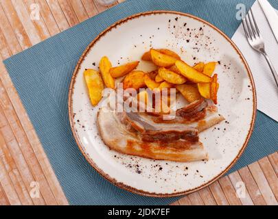 Assiette avec tranches de pommes de terre frites et poitrine de porc Banque D'Images