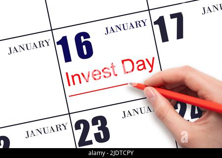16th jour de janvier. Dessiner à la main la ligne rouge et écrire le texte investir jour à la date calendrier 16 janvier. Concept commercial et financier. Mois d'hiver, Banque D'Images