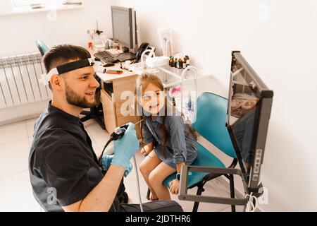 Endoscopie nasale de l'enfant. Procédure de Rhinoscopie avec rhinoscope. ORL docteur otolaryngologiste avec phare traiter nez patient enfant Banque D'Images