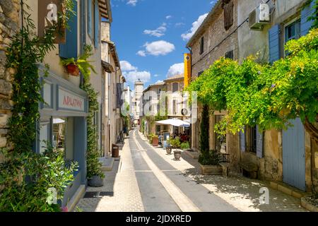 L'une des nombreuses rues et ruelles typiques de cafés et de boutiques colorés dans la ville historique de Saint-Rémy-de-Provence lors d'une belle journée d'été. Banque D'Images