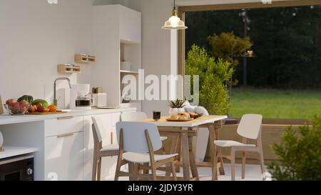 Cuisine maison confortable design intérieur avec espace de cuisine moderne, appareils de cuisine, armoires de cuisine, blanc minimal et table à manger en bois contre Banque D'Images