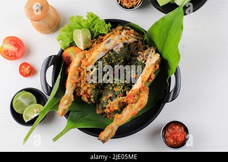 Ayam Betutu.Poulet rôti balinais farci de feuilles de manioc. Banque D'Images