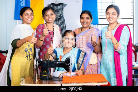 Femme avec des entraîneurs autour de montrer le pouce en regardant la caméra tout en apprenant la personnalisation à la classe - concept de l'autonomisation des femmes, de la croissance et Banque D'Images