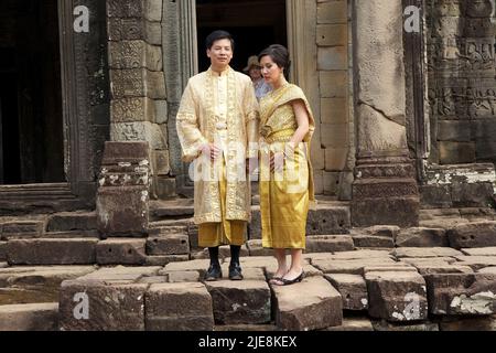 Les touristes cambodgiens dans les tissus traditionnels visitent le temple de Bayon, Angkor, Siem Reap, Cambodge. Bayon est un temple khmer à la décoration richley à Angk Banque D'Images