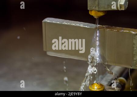 Machine de coupe de fil travaillant avec une pièce métallique avec des étincelles en usine Banque D'Images