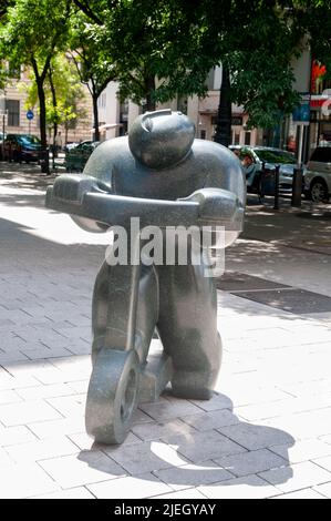 L'art de la rue de Budapest, vue sur une sculpture en granit poli d'un homme à cheval sur un scooter à l'angle de Vaci Utca et Duna Utca dans le Belvaros d Banque D'Images