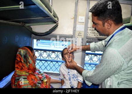 Lahore, Pakistan. 28th juin 2022. Un agent de santé administre le vaccin antipoliomyélitique à un enfant au cours d'une campagne de vaccination à Lahore, au Pakistan, en 27 juin 2022. Credit: Sajjad/Xinhua/Alay Live News Banque D'Images